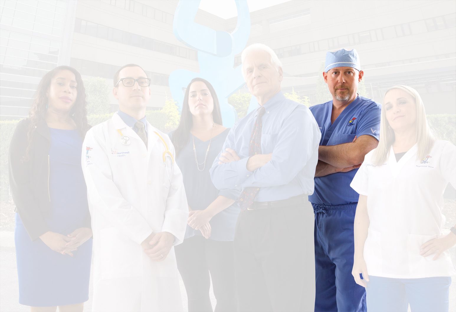 A surgeon in full operating room scrubs, including a sterile cap separates from the rest of the team and the background.